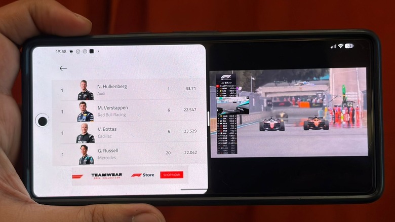 A phone in split-screen mode, showing an F1 race on the right-hand side and racer stats on the left-hand side