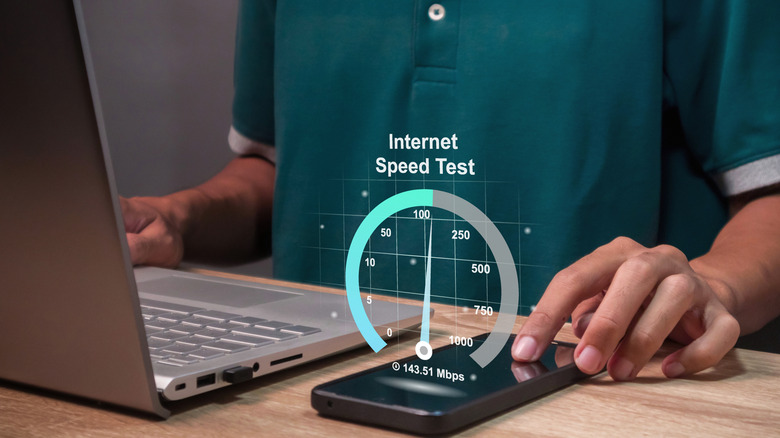 Doing an internet speed test while using both a smartphone and a laptop