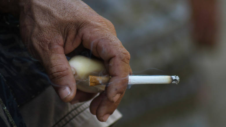 A man holding a cigarette