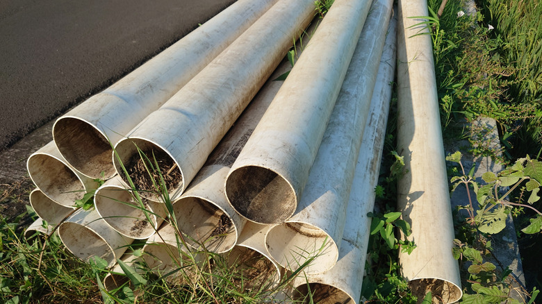 PVC pipes piled in field