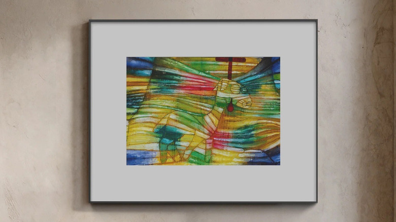 InkPoster e-ink art frame hanging on the wall in a contemporary living room