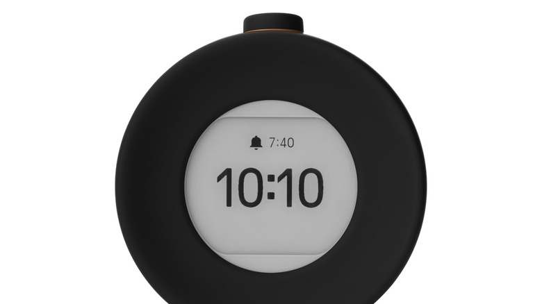 Front face of the Mudita Harmony 2 displaying the current time and alarm time.