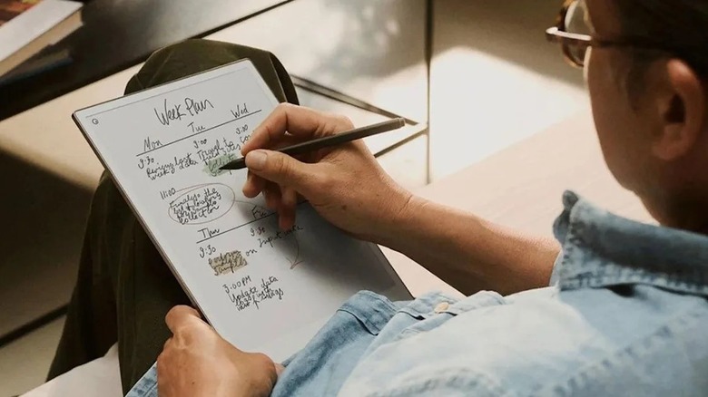 Man writing on the Remarkable Pro Pro on his lap