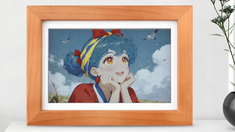 A Waveshare Photopainter digital photo frame sits on a shelf next to a house plant displaying a color manag image