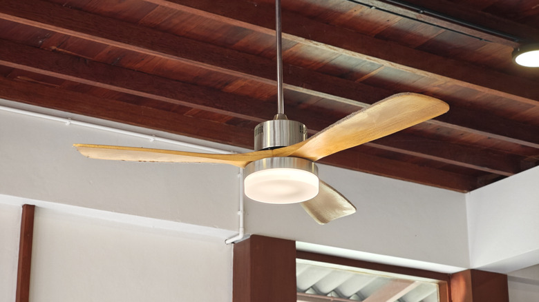 A wooden ceiling fan