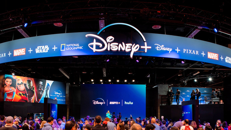 D23 Expo event in 2019 with a banner showing various brands connected to Disney Plus