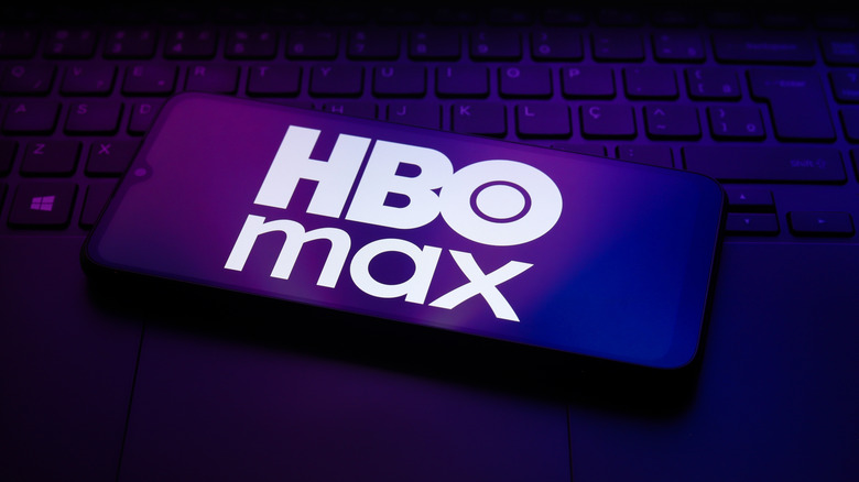 The HBO Max logo on the screen of a phone in landscape mode