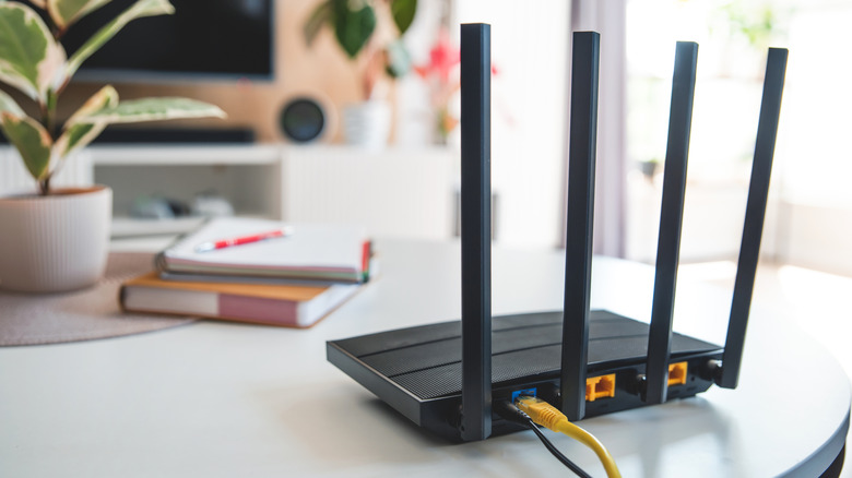 A four-antenna Wi-Fi router on a table.