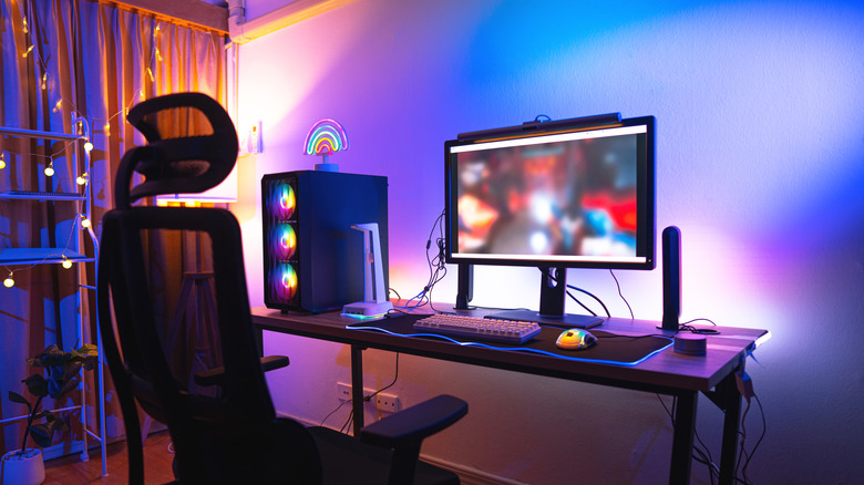 A gaming PC, covered in RGB, on a desk.