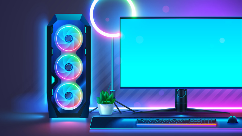 A three-fan gaming PC tower next to a monitor.