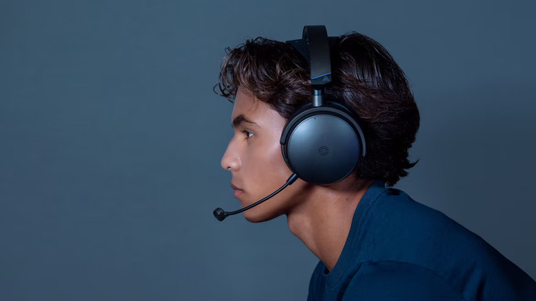 A person wearing the Audeze Maxwell 2 headphones