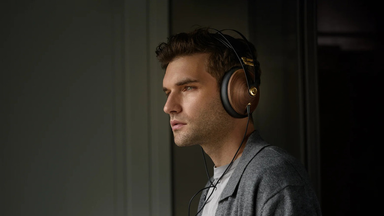 A person wearing the 2nd Gen Meze Audio 99 Classics headphones