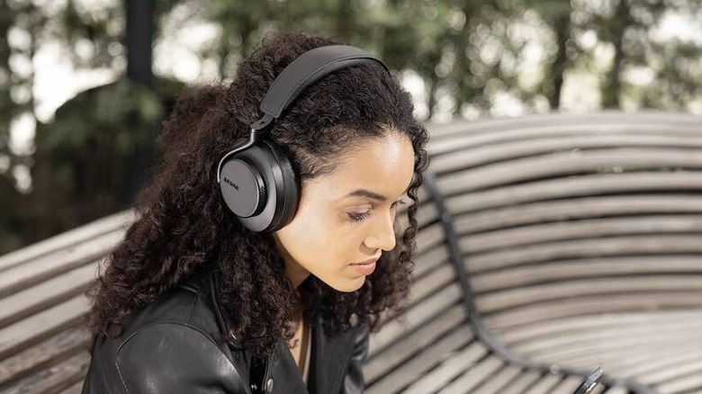 A person wearing the Shure Aonic 50 Gen 2 headphones outside