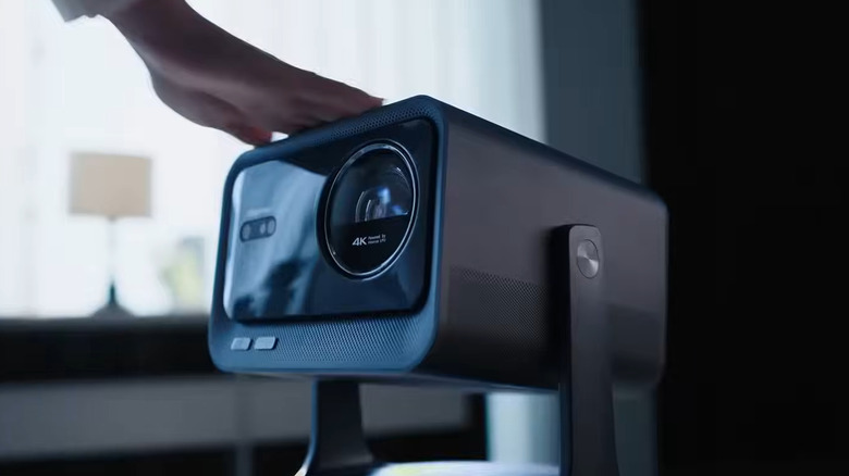 Hisense Mini Projector with a hand resting on top of it