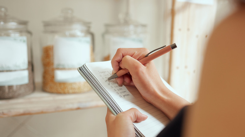 Person checking off a shopping list