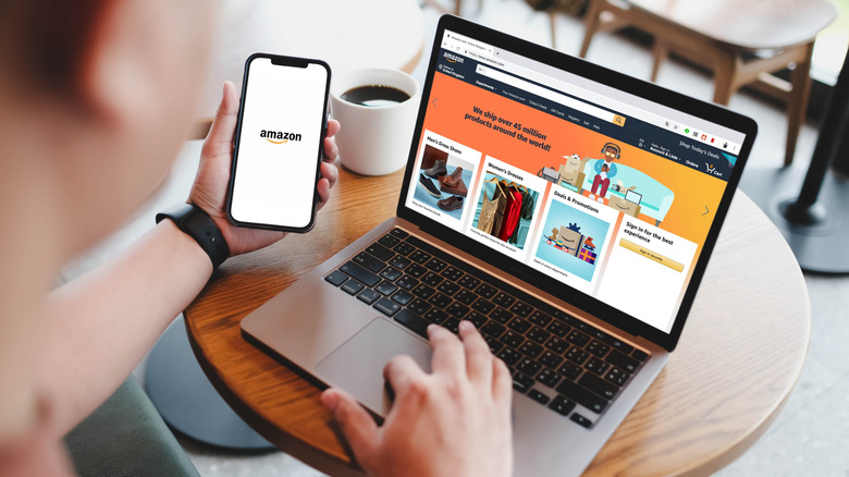 person looking at amazon page on phone and computer at the same time