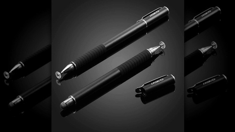 Two black stylus pens placed against a black background.