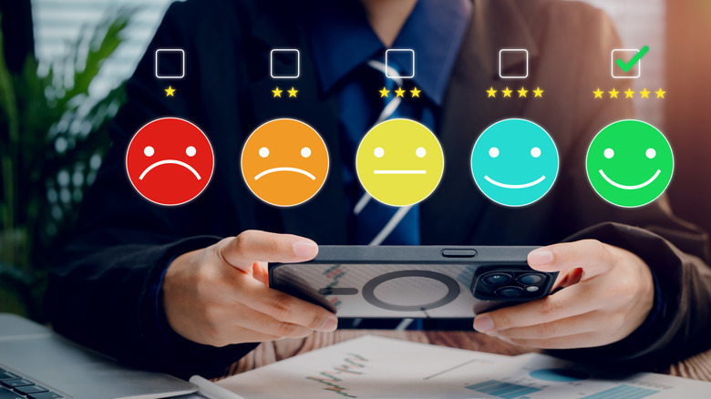 Holographic images of different emojis with ratings.