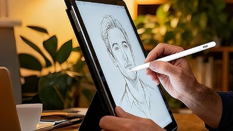 Drawing a man's sketch using a stylus on a tablet.