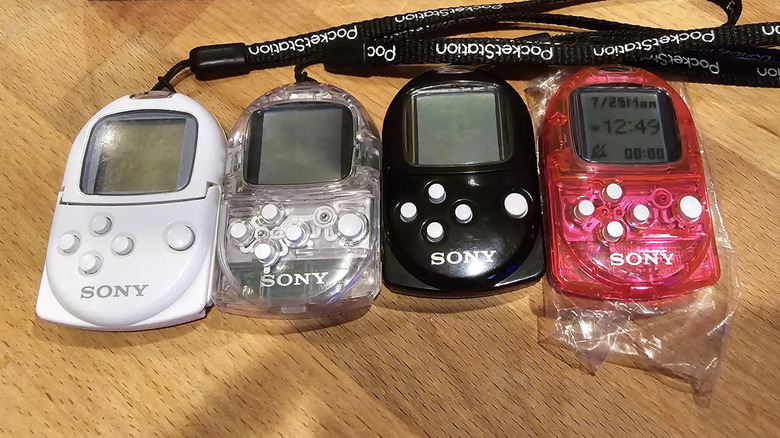 A collection of Sony's PocketStations, placed on a wooden table