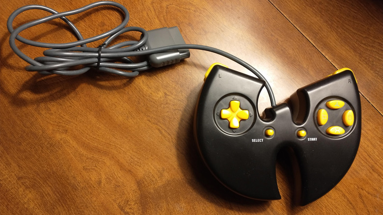 The W-shaped Wu-Tang: Shaolin Style controller placed on a wooden table