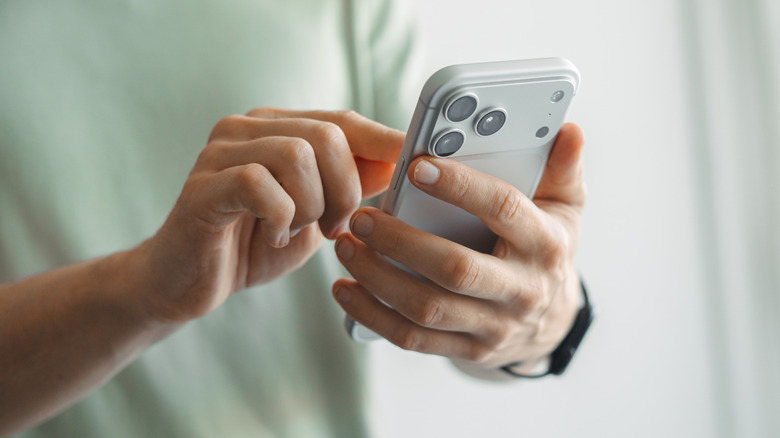 A tech enthusiast using an iPhone to find overlooked features.