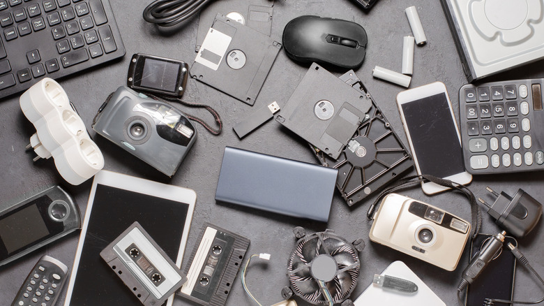 Top down view of old electronic gadgets on a black background