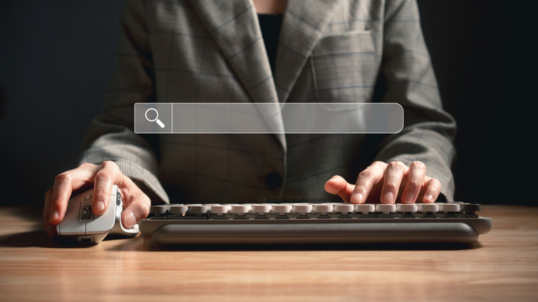 Hands on keyboard and mouse with middle button while searching online
