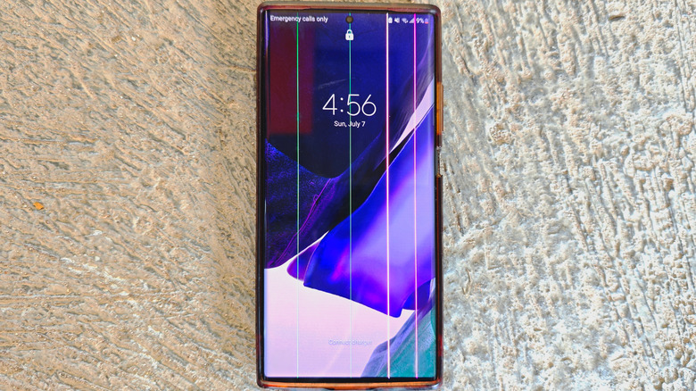 A defective smartphone display featuring dead pixels in vertical lines