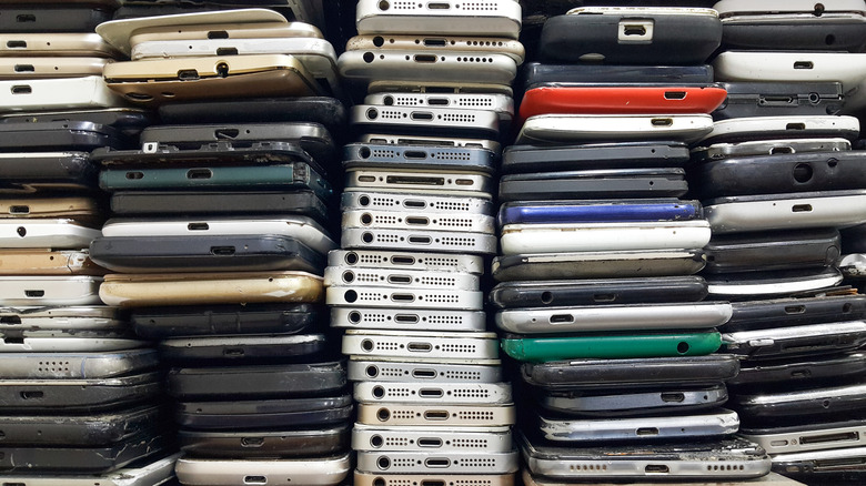 Used phones in various colors stacked on top of each other