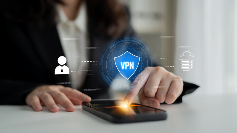 A person using a phone with a VPN logo floating over it