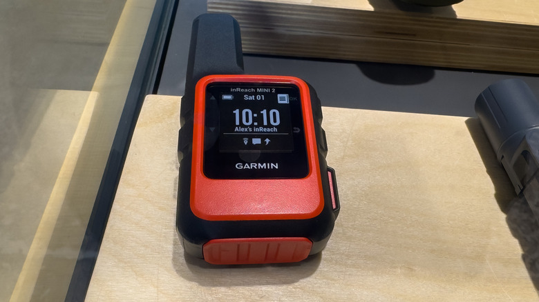 Red colored inReach mini 2 satellite communicator placed on a table