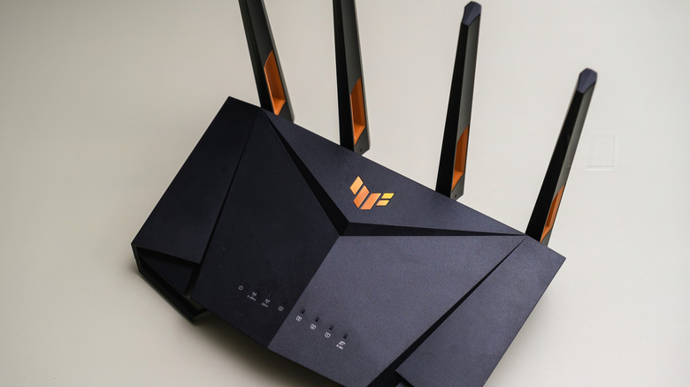 The ASUS TUF Gaming AX4200 gaming router on a beige surface