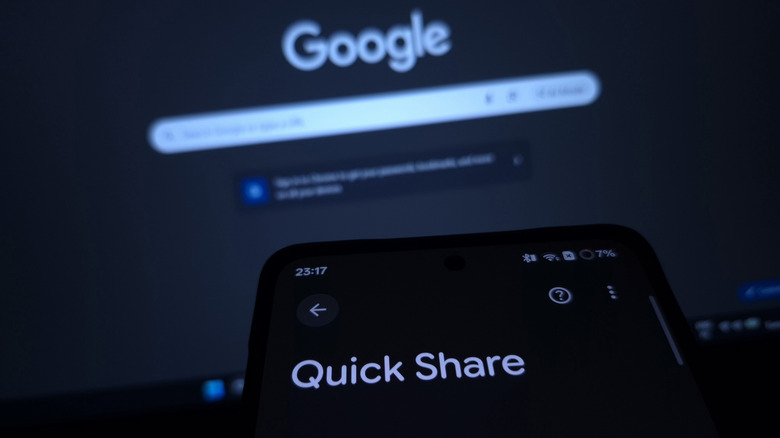 A person using Quick Share on their phone in front of the Google home screen