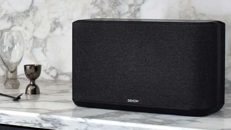 Denon speaker placed horizontally on a marble table
