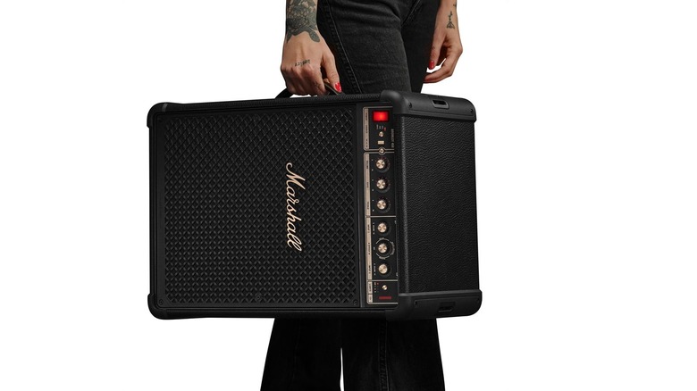 A person carrying the Marshall Bromley 450 using its side strap, against a white background.