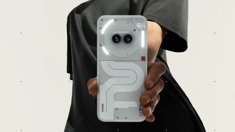 A white Nothing Phone (2a) held in a man's hand