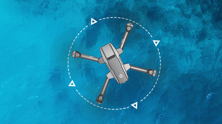 Holy Stone HS440 flying over an ocean with a motorboat sailing by.