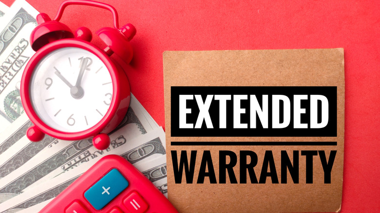 bank notes, alarm clock, calculator, and the word extended warranty