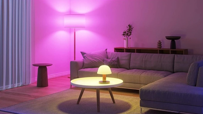 Sitting lounge lit up with different colors -- pink and warm yellow