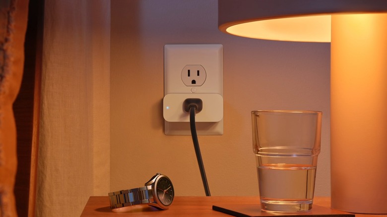 Amazon smart plug powering a bedside lamp