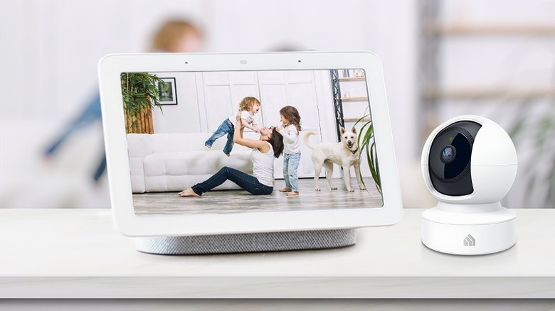 Kasa camera placed beside a smart screen