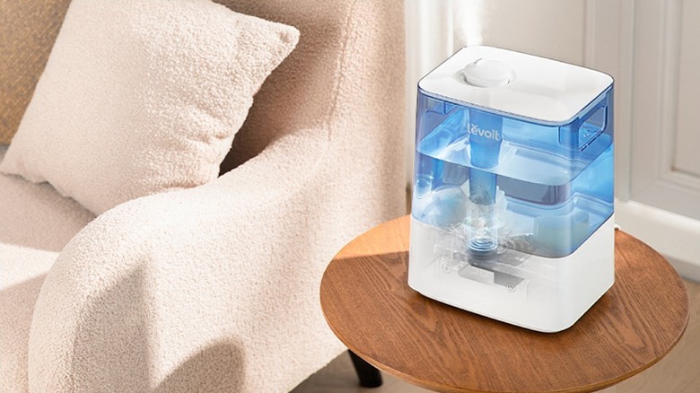 Levoit humidifier placed on a small round wooden table