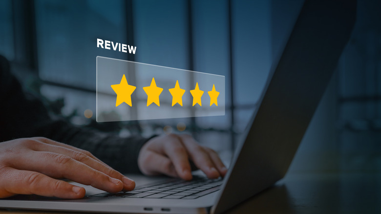 Holographic review bar over a laptop