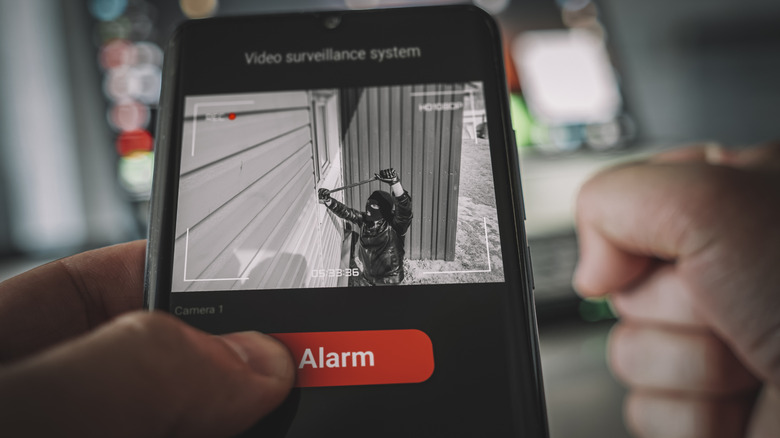 person-watching-thief-from-sceurity-camera