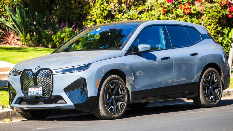 2024 BMW iX parked in a residential street.