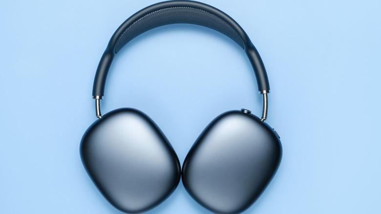 A pair of blue Airpods Max on a blue background