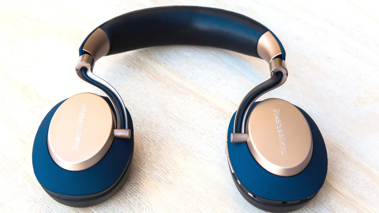 A pair of sleek B&W headphones on a white tabletop