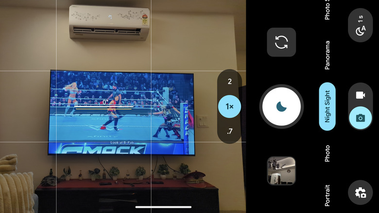 A camera in Night Sight mode pointed at a television and air conditioner