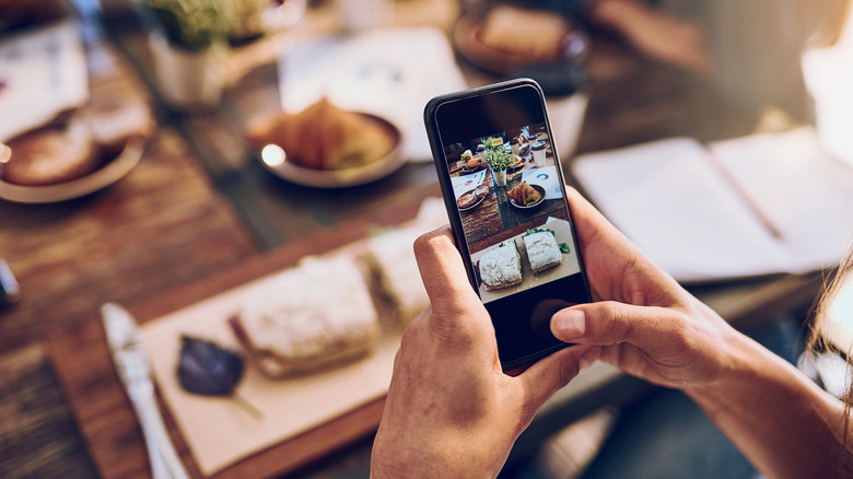 A person taking a picture of their food with their smartphone
